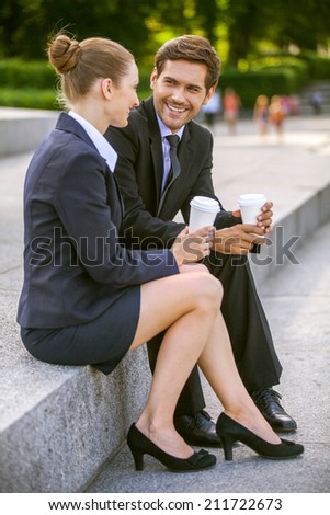 Business people drinking coffee outside. Business partners discussing while on stairs