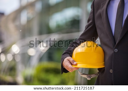 professional engineer holding yellow helmet. workers security isolated on white background