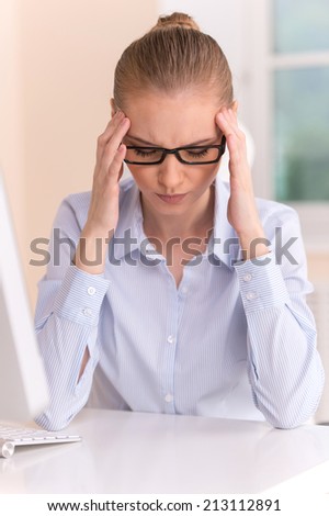 Close up portrait of woman with headache at office. Closeup on stressed business woman in foreground
