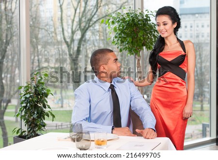 Handsome man waiting woman and looking back. woman standing behind late to date