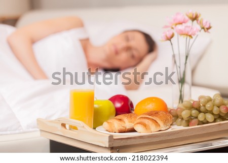 Beautiful woman with breakfast in bed early. woman sleeping in bed on white pillow