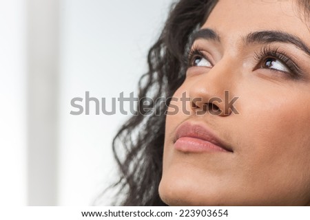 beautiful indian woman looking up on white background. Portrait of pretty Indian female model