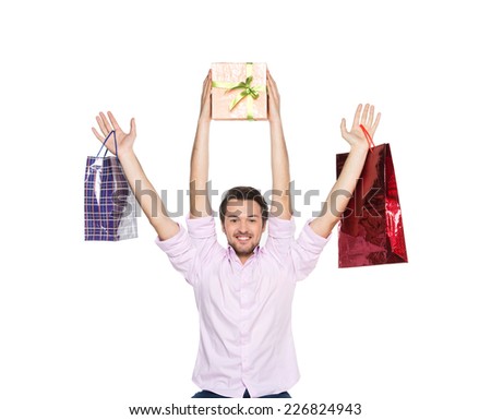 Man lifted presents up isolated on white background. waist up of guy with four hands holding bags