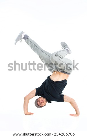 young break dancer showing his skills on white background. Hip hop dancer man performing isolated over white background