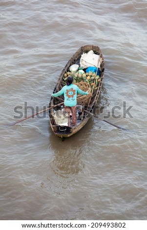 Can Tho, Vietnam - APRIL 2: Woman on boat floating down Mekong river at Can Tho Floating Market, Can Tho, Mekong Delta, Vietnam on April 2, 2014.