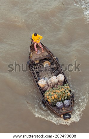 Can Tho, Vietnam - APRIL 2: Woman on boat floating down Mekong river at Can Tho Floating Market, Can Tho, Mekong Delta, Vietnam on April 2, 2014.