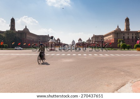 Delhi, India - 17 September 2014: Indian man riding the bicycle in front of the Delhi Government buildings on 17 September 2014, Delhi, India.