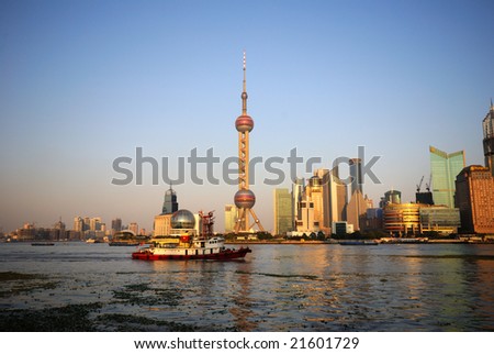 A boat cruises past the Oriental Pearl building on the Huangpu River in Shanghai.
