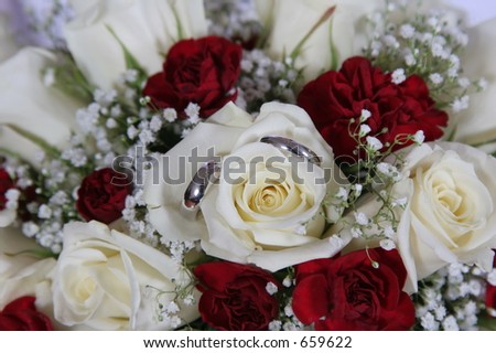 Wedding bands in the petals of the brides bouquet