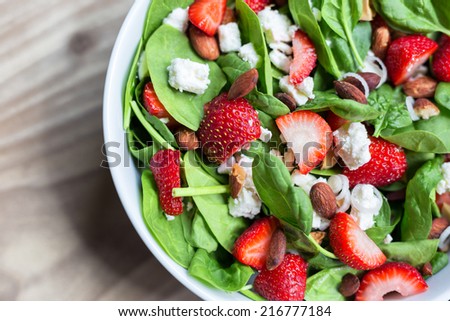 Spinach salad with strawberries, scallions, coconut toasted almonds and goat cheese.