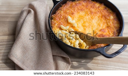 Southern style macaroni and cheese baked in a cast iron Dutch oven.