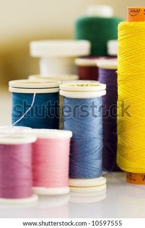 macro of thread in different colors. Focus on the yellow thread.