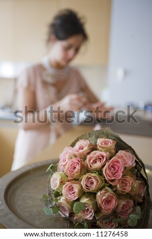 Wedding flowers. woman painting nails for wedding on background.