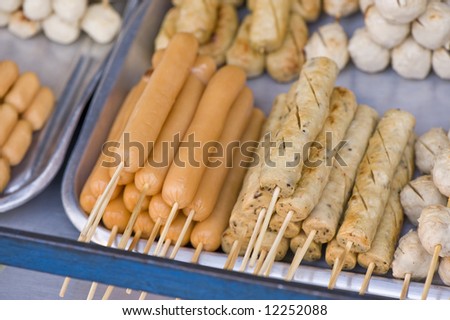 sticks with meat and fish products on market in Thailand.