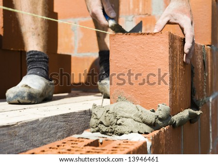 construction worker building a wall