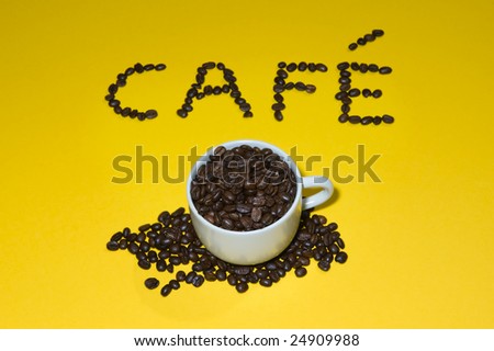 cafe written with beans on yellow background.