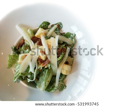 Caesar salad with baked bread and cheese on White background