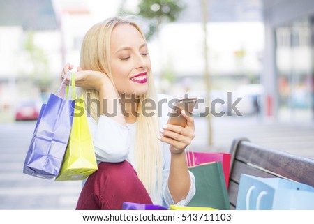 Shopper shopping with smartphone in the street
