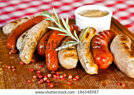 Grilled assorted sausages with spices and rosemary
