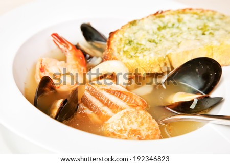 Fish soup with prawns, mussels, salmon and toasted garlic bread