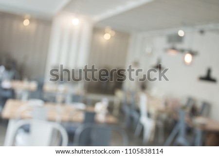 Blurred interior design with bright white lighting and hanging lights in cafe or restaurant.
