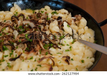 spaetzle with melted cheese in pan