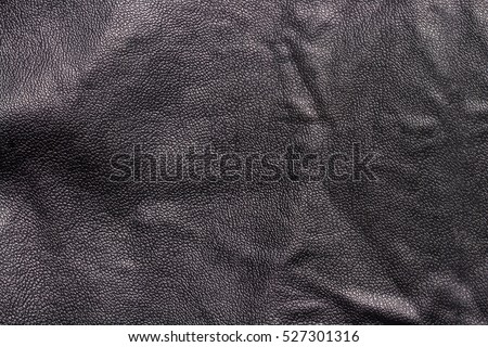 Texture of black leather on the back of a black leather jacket