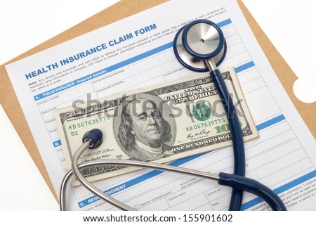 Medical reimbursement with health insurance claim form and stethoscope on cash isolated
