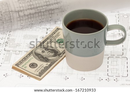 Coffee cup and money on architectural design and drawing