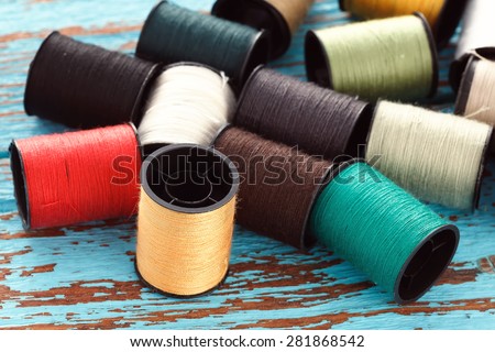 colorful thread needlework embroidery tailor craft repair background blue wood teak still life vintage
