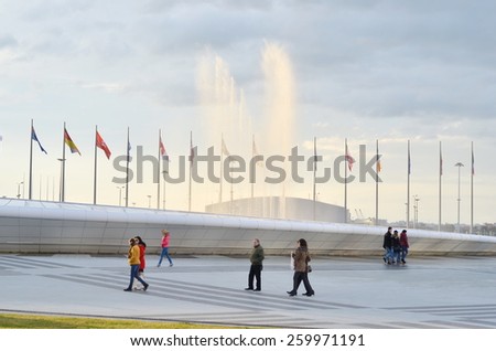SOCHI, RUSSIA-February, 7 2015: Flagpoles,water fountain and tourists in olympic park in Sochi, Russia.  One year after XXII Winter Olympic Games.