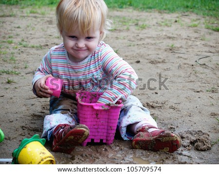 bedraggled baby play with  sand