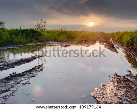 Deep puddle on a dirty road