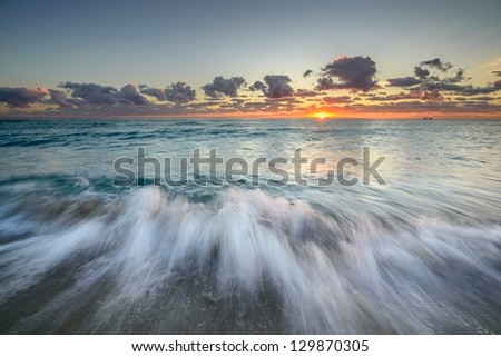 Ocean landscape with blurred waves and sun