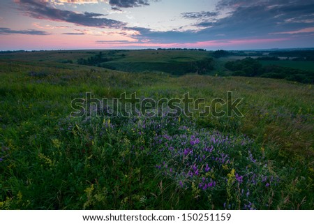 Natural colours summer sunrise over fields and hills in Russia