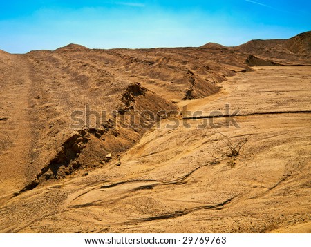 Bright and saturated shot of a sand dunes and lonely spike.