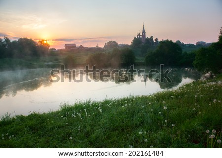 Early morning sunrise village in Russia. Landscape with a church at the hill top