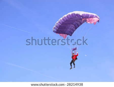 A purple parachute in a blue sky on a sunny day