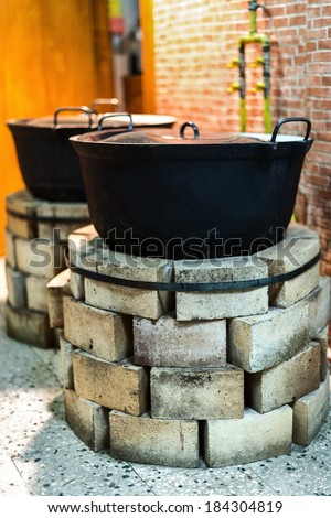 Brick ovens with old pots in the kitchen