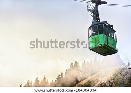 Cable car with passengers descending from the top