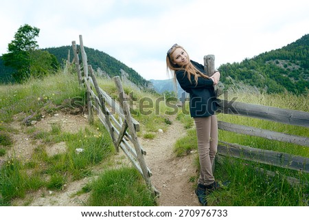 Pretty young female in the countryside, being happy