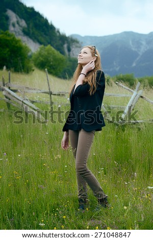 Beautiful woman with flower in hair, looking at the sky, relaxed