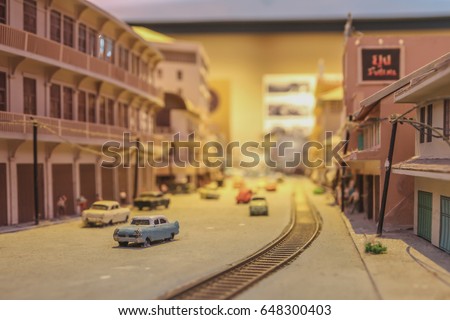 Selective focus of Town model which consist building, car and people.