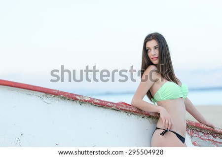 Portrait of a beautiful woman\'s back side, looking straight at the camera