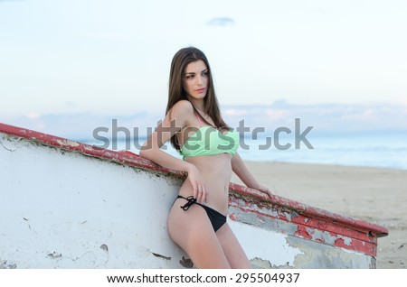 Portrait of a beautiful woman\'s back side, looking straight at the camera