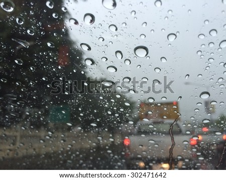 Rain with glass a car.Focus point.