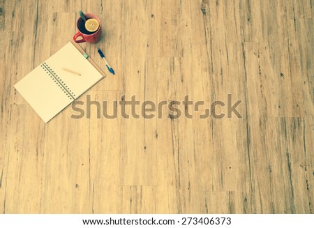 Office background: Blank notepad, pen and cup of tea on a wooden table, lot of copy space