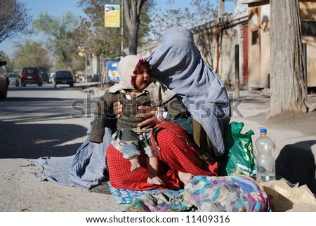 Woman in burka begging