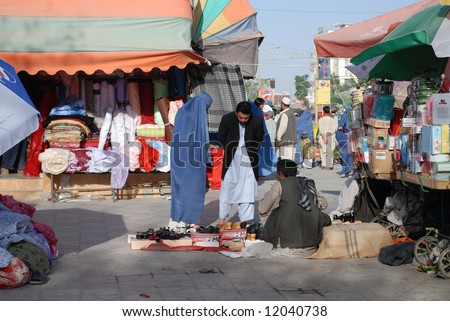 عكسهاي افغانستان Stock-photo-woman-in-burka-buys-shoes-12040738