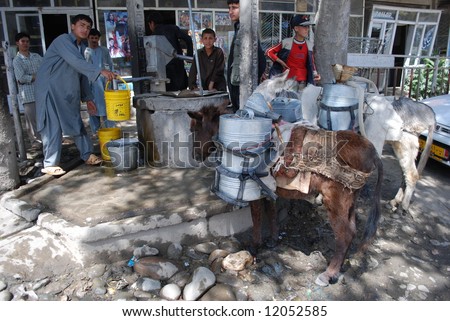 Afghan boys pump water